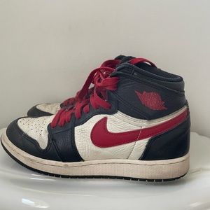 Black, red and white Nike high tops.